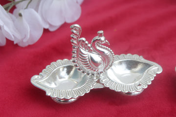 peacock with 2 side diya,  peacock with 4 haladi kumkum holder german silver return gifts, wedding favo golu pooja favors, varalakshmi gifts